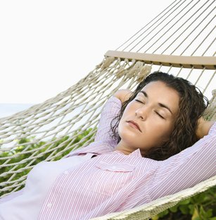 Whitney leaning against a railing on a downtown street