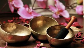 Whitney leaning against a railing on a downtown street